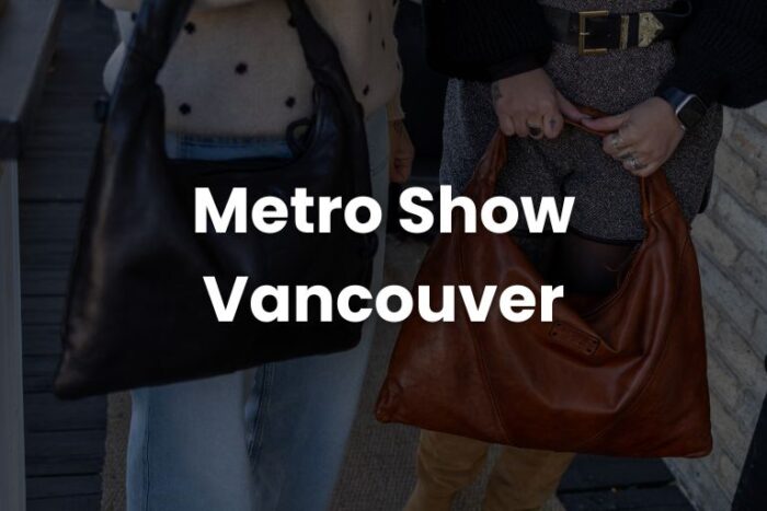 two women holding leather handbag with text